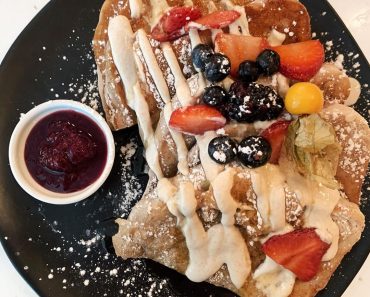Maple cinnamon french toast with vanilla crema, berry compote, fresh fruit, and …